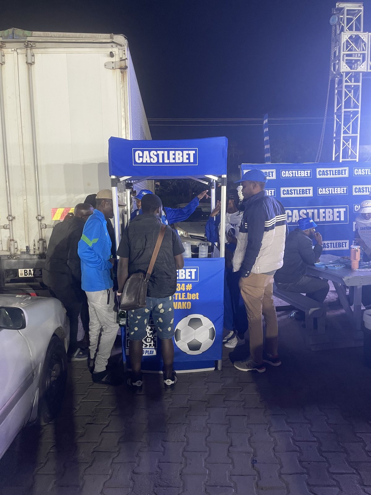 Attendees engaging with the CastleBet booth during the evening activation