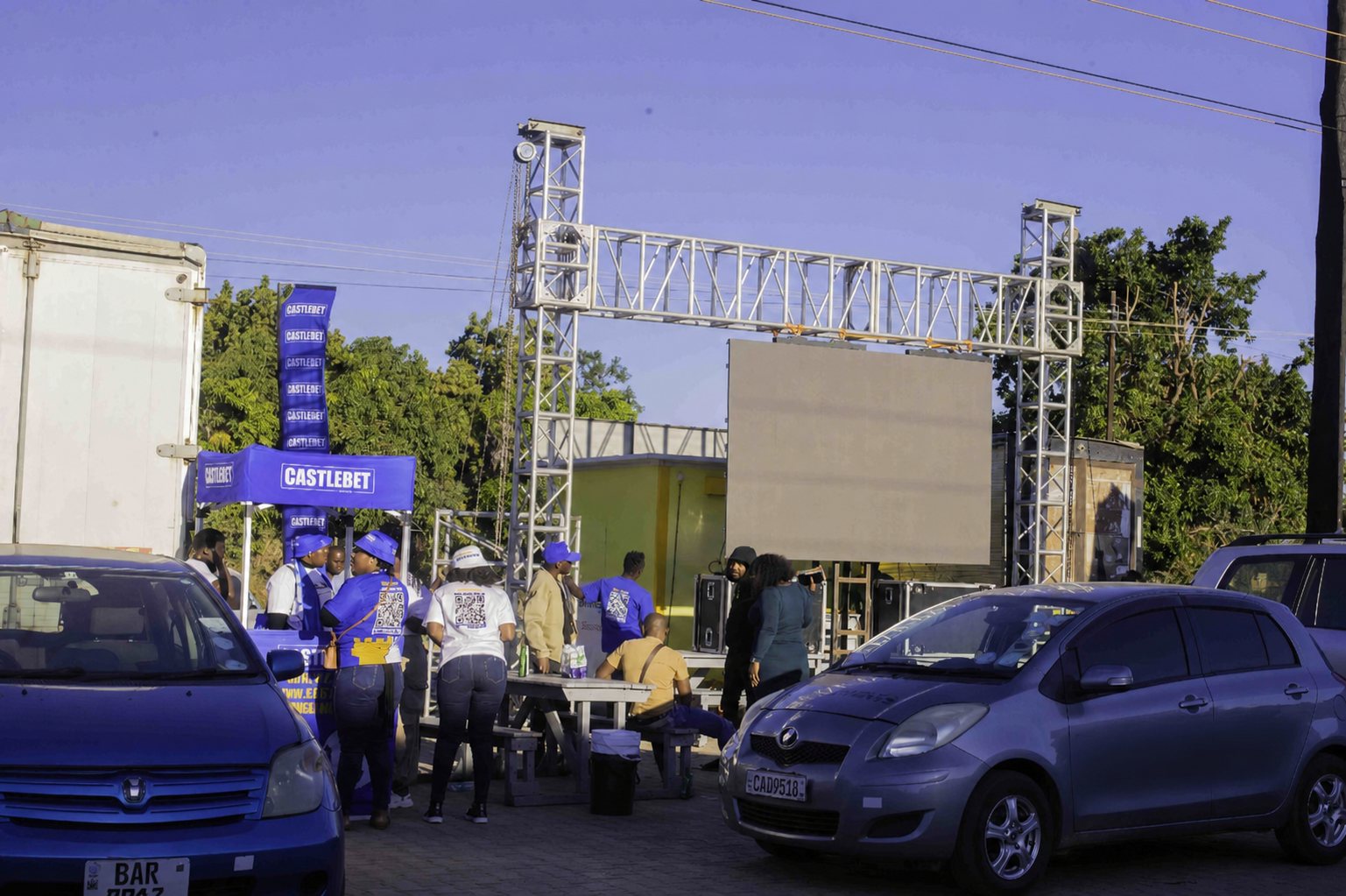 CastleBet UEFA Champions League activation setup with a large outdoor screen, branded engagement booth and promoter team